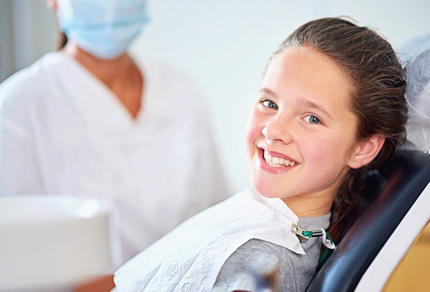 Young patient smiling after fluoride treatment