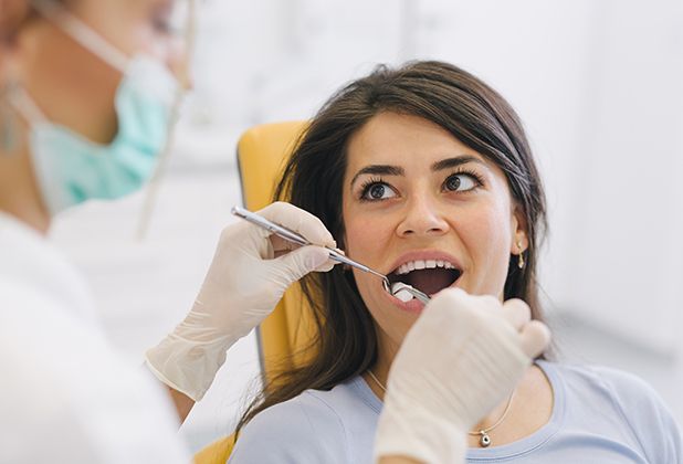 Woman receiving tooth extraction